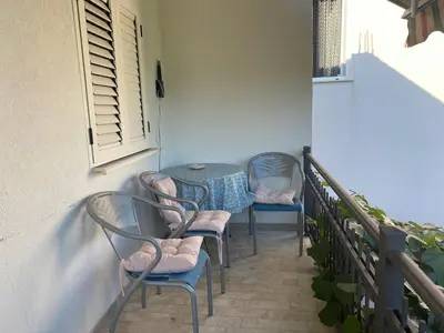 a table and chairs sitting on a balcony at Apartmani Čavor in Budva