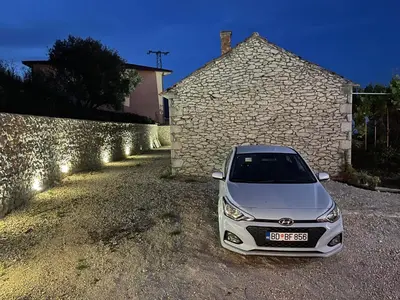 a silver car parked in front of a building at Imperator Apartments in Ulcinj
