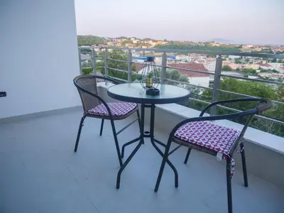 a table and two chairs on a balcony with a view at Imperator Apartments in Ulcinj