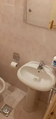 a bathroom with a sink and a toilet and a mirror at Apartman Vuk in Budva