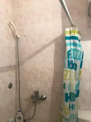 a shower with a shower curtain in a bathroom at Apartman Vuk in Budva