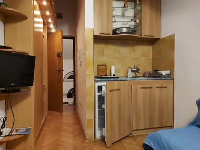 a small kitchen with a sink and a counter at Apartman Vuk in Budva