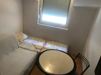 a small room with a table and a window at Apartman Vuk in Budva