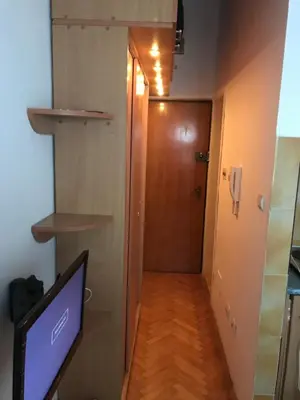 a hallway with a door and a computer monitor in a room at Apartman Vuk in Budva