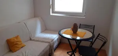 a small room with a table and a chair at Apartman Vuk in Budva