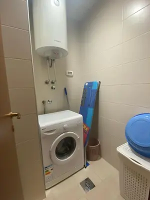 a small bathroom with a washing machine and a toilet at Apartment Vesna City PG in Podgorica