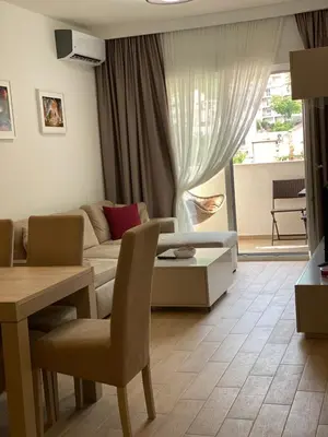 a living room with a couch and a table at E3 Apartment in Budva