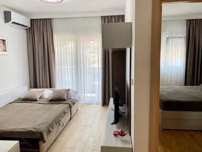 a bedroom with a bed and a television in it at E3 Apartment in Budva