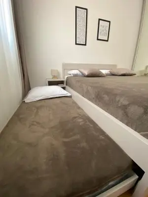 two beds sitting next to each other in a bedroom at E3 Apartment in Budva