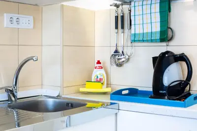 a kitchen counter with a sink and utensils at VILA TARA in Sutomore