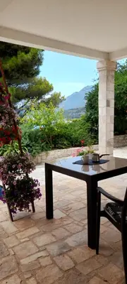 a table and a chair on a patio at VILA TARA in Sutomore