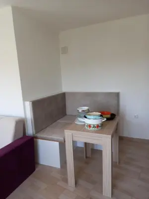 a small table with bowls and plates on it at MD APARTMANI CANJ in Čanj