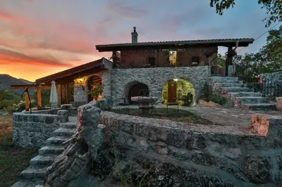 a stone house with a stone wall at Royal Villa Ana in Cetinje