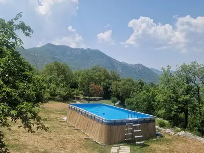 a large swimming pool with a ladder next to it at Royal Villa Ana in Cetinje