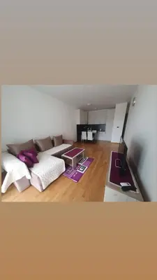 a living room with a couch and a table at Apartman Krstajić in Budva