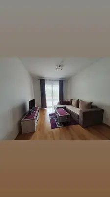 a living room with a couch and a table at Apartman Krstajić in Budva