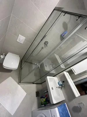 a bathroom with a sink and a toilet and a mirror at Apartman Krstajić in Budva
