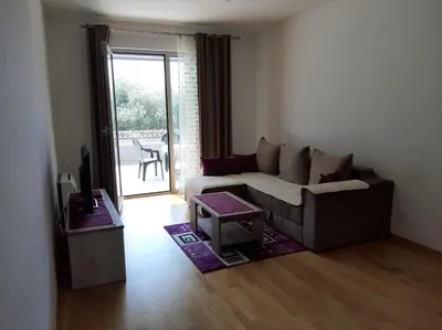 a living room with a couch and a table at Apartman Krstajić in Budva