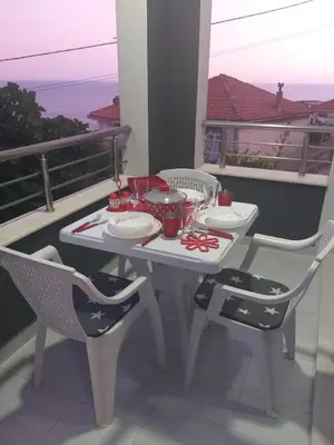 a white table and chairs on a balcony at Helena Apartment in Ulcinj