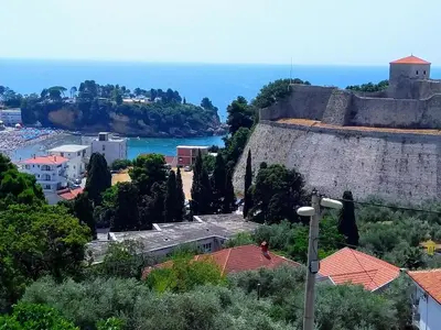 a view of a city with a castle and the ocean at Helena Apartment in Ulcinj