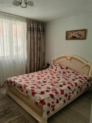 a bedroom with a bed with a red and white blanket at DUBRAVA 115 in Dobra Voda