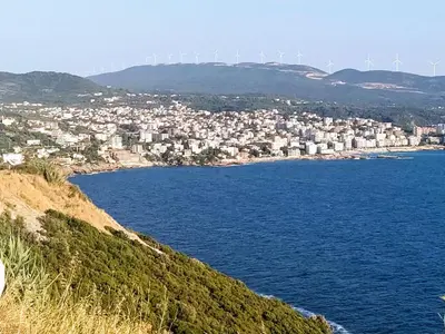 a view of a city with windmills in the distance at DUBRAVA 115 in Dobra Voda