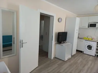 a room with a kitchen and a tv in a room at DUBRAVA 115 in Dobra Voda