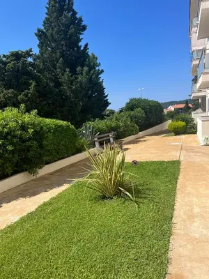 a park with a bench in a grassy yard at Adriatic apartman in Becici