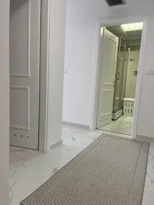 a white room with a mirror and a rug at Adriatic apartman in Becici