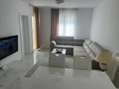 a living room with a couch and a tv at Adriatic apartman in Becici