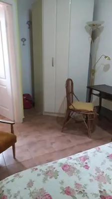 a room with a bed and a chair and a table at Apartment 2 in Bar, Susanj