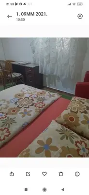 two beds in a room with flowers on them at Apartment 2 in Bar, Susanj
