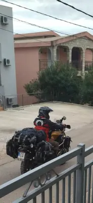 a person on a motorcycle parked on the street at Apartment 2 in Bar, Susanj