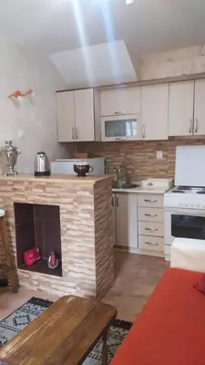 a kitchen with a fireplace in the middle of it at Apartment 2 in Bar, Susanj