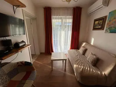 a living room with a couch and a window at Apartment 2 in Bar, Susanj