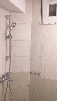 a shower in a bathroom with a shower head at Apartment 2 in Bar, Susanj