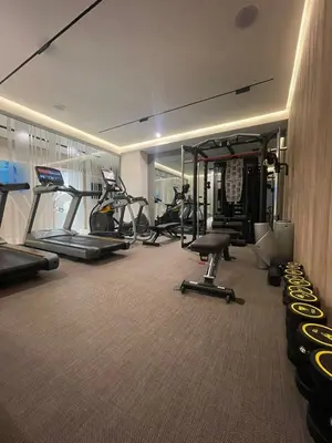 a gym with several treadmills and exercise bikes at Katamare Hotel in Budva