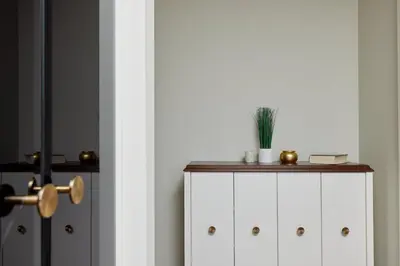 a white cabinet with a plant on top of it at Przice Gardens Apartment with Pool in Kotor