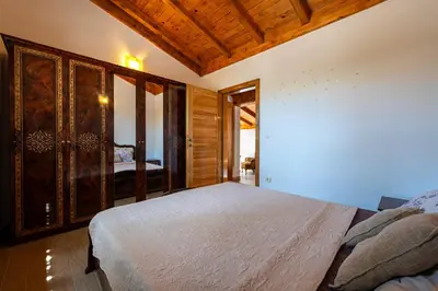 a bedroom with a bed and a wooden ceiling at Villa Helena in Kotor