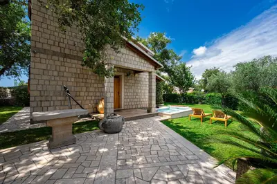 a patio with a bench next to a house at Villa Helena in Kotor