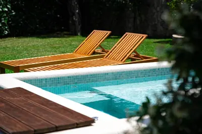 two chairs sitting next to a swimming pool at Villa Helena in Kotor