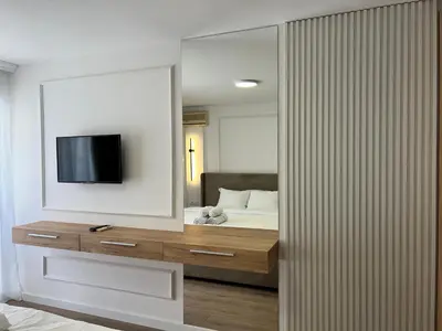 a bedroom with a bed and a tv on a wall at Donna in Ulcinj