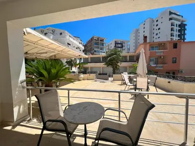 a balcony with a table and chairs on a roof at Donna in Ulcinj