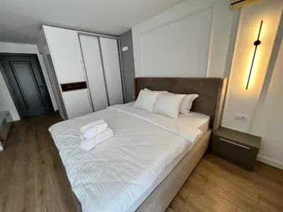 a large bed with white sheets and towels on it at Donna in Ulcinj