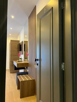 a hallway with a bathroom with a desk and a door at Donna in Ulcinj