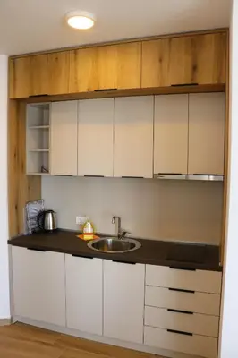 a kitchen with white cabinets and a sink at Eagles Apartments & Suites in Ulcinj