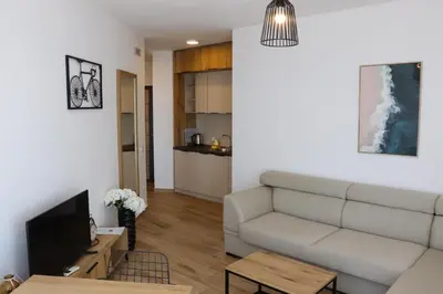 a living room with a couch and a tv at Eagles Apartments & Suites in Ulcinj