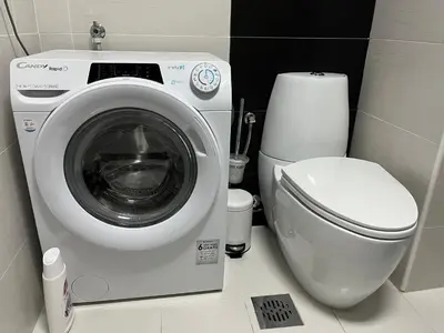 a bathroom with a washing machine and a toilet at Apartment MERCURY in Budva