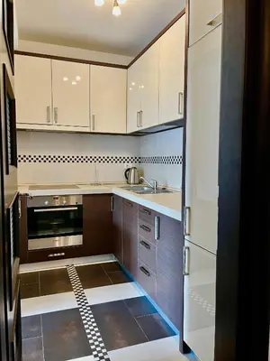 a kitchen with white cabinets and a stove top oven at Apartment MERCURY in Budva