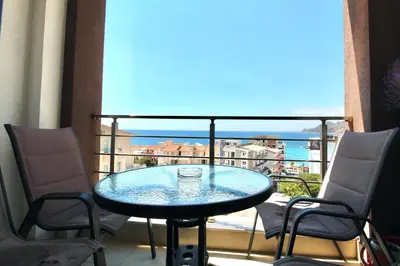 a glass table on a balcony with a view of the ocean at 1bd Sea View Apts Veliki Pjesak 